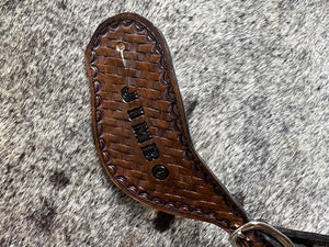 Hand tooled and painted basket weave spur straps.