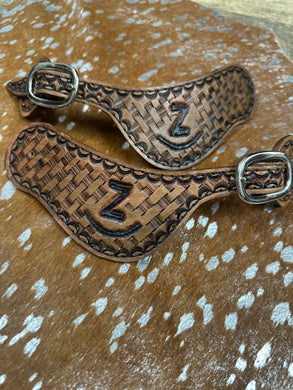 Hand tooled and painted Custom Brand spur straps basketweave.