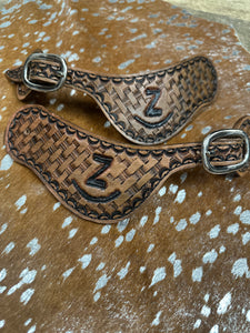 Hand tooled and painted Custom Brand spur straps basketweave.