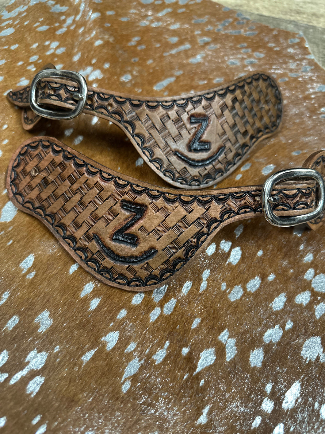 Hand tooled and painted Custom Brand spur straps basketweave.